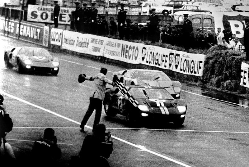 Ken-Miles-centre-Ford-crossing-the-1966-Le-Mans-finish-line-with-the-other-two-Fords